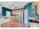 Well-equipped kitchen with stainless steel appliances, wooden cabinets, and dark teal accent wall at 16994 Folly Brook Rd, Noblesville, IN 46060