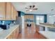 Bright kitchen features wooden cabinets, stainless steel appliances, hardwood floors, and a ceiling fan at 16994 Folly Brook Rd, Noblesville, IN 46060
