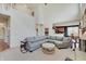 Bright living room featuring a staircase, fire place and sectional couch at 16994 Folly Brook Rd, Noblesville, IN 46060