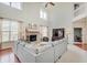 Bright living room featuring a vaulted ceiling, a gray sofa, and a brick fireplace at 16994 Folly Brook Rd, Noblesville, IN 46060