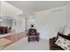 Open-concept living area leading to the dining room, features a comfortable leather chair at 16994 Folly Brook Rd, Noblesville, IN 46060