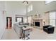Bright living room with a vaulted ceiling, a gray sofa, and a brick fireplace at 16994 Folly Brook Rd, Noblesville, IN 46060
