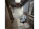 Bathroom with a tub, toilet, and damaged walls and floor, reflecting its state of disrepair at 1704 E Kirk St, Muncie, IN 47303