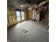 Damaged room with missing ceiling pieces, exposed insulation and framing at 1704 E Kirk St, Muncie, IN 47303