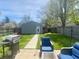 Spacious backyard featuring a detached garage, patio furniture, grill, and a lush lawn with mature trees at 1749 E 52Nd St, Indianapolis, IN 46205