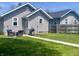 Exterior view of a home with a landscaped backyard including patio furniture, a grill, a lawn and a fenced yard at 1749 E 52Nd St, Indianapolis, IN 46205
