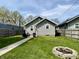 Spacious backyard with a stone fire pit, seating area, and well-maintained lawn at 1749 E 52Nd St, Indianapolis, IN 46205