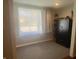 Bright bedroom with a large window, gray carpet, neutral walls, and a large Liberty safe for secure storage at 1749 E 52Nd St, Indianapolis, IN 46205