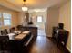 Open-concept dining area with hardwood floors and a view of the modern kitchen at 1749 E 52Nd St, Indianapolis, IN 46205