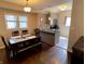 Open-concept dining area with hardwood floors and a view of the modern kitchen at 1749 E 52Nd St, Indianapolis, IN 46205