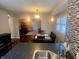 Open-concept kitchen and dining area featuring modern lighting, stone countertops, and seamless transition into the living room at 1749 E 52Nd St, Indianapolis, IN 46205