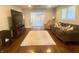 Spacious living room featuring hardwood floors, neutral walls, comfortable seating, and a seamless flow to other spaces at 1749 E 52Nd St, Indianapolis, IN 46205