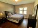 Serene main bedroom featuring hardwood floors, a comfortable bed, and lots of natural light at 1749 E 52Nd St, Indianapolis, IN 46205