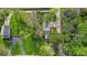Aerial view of home on a treed lot, surrounded by green lawns and flowering trees at 1917 W 58Th St, Indianapolis, IN 46228