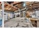 Unfinished basement with exposed beams, concrete floor, washer and dryer, and some storage at 1917 W 58Th St, Indianapolis, IN 46228