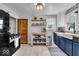 Stylish kitchen features blue cabinets, butcher block counters, and stainless steel appliances at 1917 W 58Th St, Indianapolis, IN 46228