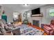 Inviting living room features a fireplace, hardwood floors, and views of the dining area at 1917 W 58Th St, Indianapolis, IN 46228