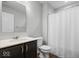Well-lit bathroom featuring a vanity, toilet, and a shower with a white curtain at 19283 Donelson Ln, Westfield, IN 46062