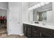 Bathroom featuring double sinks, dark wood cabinets, and a large mirror at 19283 Donelson Ln, Westfield, IN 46062