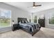 Comfortable bedroom with a ceiling fan, large windows, and neutral carpet at 19283 Donelson Ln, Westfield, IN 46062