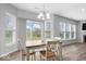 Bright dining area features a table for four and large windows that let in plenty of natural light at 19283 Donelson Ln, Westfield, IN 46062