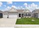 Charming single-story home boasts a three-car garage, manicured lawn, and welcoming entrance at 19283 Donelson Ln, Westfield, IN 46062