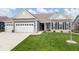 Charming single-story home featuring a manicured lawn, a two-car garage, and a welcoming entryway at 19283 Donelson Ln, Westfield, IN 46062