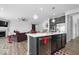Open-concept kitchen and living area featuring modern appliances and a stylish breakfast bar at 19283 Donelson Ln, Westfield, IN 46062