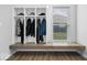 Bright mudroom boasts custom storage lockers, a comfortable bench, and stylish wood-look flooring at 19283 Donelson Ln, Westfield, IN 46062
