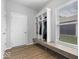 Bright mudroom with storage lockers, bench, and wood-look flooring, conveniently located near the entry door at 19283 Donelson Ln, Westfield, IN 46062