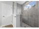 Walk in shower with gray tile, glass enclosure, and a shower head at 19283 Donelson Ln, Westfield, IN 46062