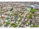 A wide aerial shot shows a neighborhood with closely spaced houses, tall green trees and blue buildings at 2001 S I St, Elwood, IN 46036