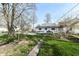 A view of a white house with a fenced backyard from the end of a concrete walkway at 2001 S I St, Elwood, IN 46036