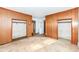 Bedroom with wood paneling, neutral carpet and closet storage at 2001 S I St, Elwood, IN 46036