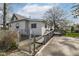 Exterior view of a home with gray siding, black windows, and a small chainlink fence at 2001 S I St, Elwood, IN 46036