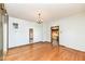 Bright living room featuring hardwood floors and white walls, lit by a vintage chandelier at 2001 S I St, Elwood, IN 46036