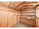 Wooden shed interior featuring plywood walls, a plywood floor, and built-in wooden shelves at 2001 S I St, Elwood, IN 46036
