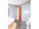 Bathroom featuring a soaking tub, toilet, and built-in storage, designed for convenience and relaxation at 2088 Brandywine Ln, Martinsville, IN 46151