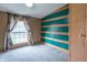 Bright bedroom featuring a vibrant accent wall and a large window for natural light, offers a unique charm at 2088 Brandywine Ln, Martinsville, IN 46151