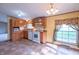 Bright kitchen featuring oak cabinets, white appliances, and ample natural light at 2088 Brandywine Ln, Martinsville, IN 46151