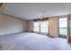 Bright, spacious living room with neutral carpet and backyard access at 2088 Brandywine Ln, Martinsville, IN 46151