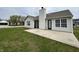 Backyard showcases a concrete patio, lush lawn, and exterior view of the home at 2344 Orchard Creek Dr, Columbus, IN 47201