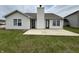Exterior featuring a large patio, lush green lawn, and a charming home exterior at 2344 Orchard Creek Dr, Columbus, IN 47201