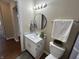 Bright bathroom showcasing a round mirror, white vanity, and decorative accents at 2344 Orchard Creek Dr, Columbus, IN 47201
