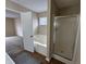 Relaxing bathroom with a soaking tub and a separate glass-enclosed shower at 2344 Orchard Creek Dr, Columbus, IN 47201