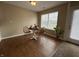 Cozy dining area with hardwood floors, a round table, and a charming window view at 2344 Orchard Creek Dr, Columbus, IN 47201