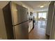 A bright kitchen with stainless steel refrigerator, appliances, and eat-in dining area at 2344 Orchard Creek Dr, Columbus, IN 47201
