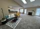 Inviting living room with skylights, vaulted ceiling, and seamless flow into the dining area at 2344 Orchard Creek Dr, Columbus, IN 47201