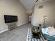 Comfortable living room showcasing vaulted ceilings, plush carpeting, and contemporary furnishings at 2344 Orchard Creek Dr, Columbus, IN 47201