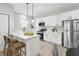 Modern kitchen featuring white cabinets, stainless steel appliances, and a breakfast bar at 2352 Stuart St, Indianapolis, IN 46218